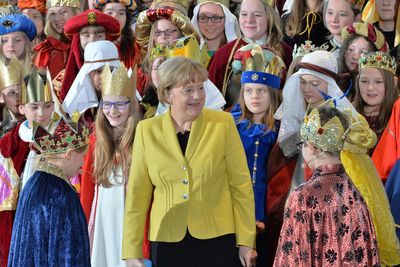 Bundeskanzlerin Angela Merkel inmitten vieler Sternsinger die zum Besuch im Bundeskanzleramt sind. 