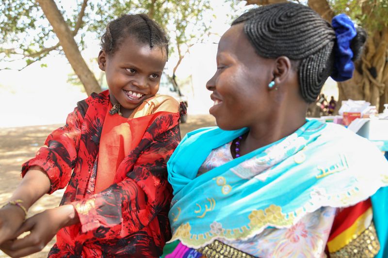 Perinah Joseph Santino with her mother Antoinette Hassan at a mobile clinic in Ngonjeko village, Wau