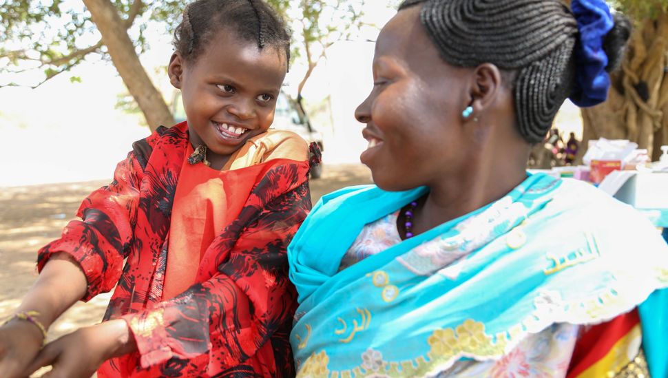 Perinah Joseph Santino with her mother Antoinette Hassan at a mobile clinic in Ngonjeko village, Wau